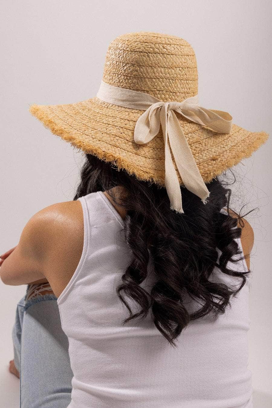 tan woven summer hat with white bow