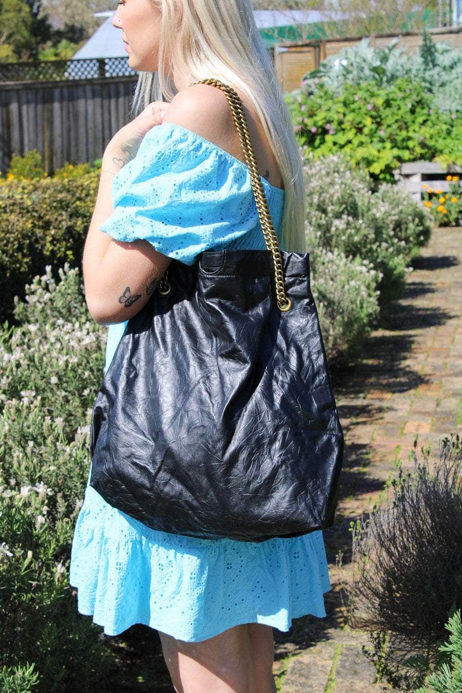 Black leather handbag with gold strap