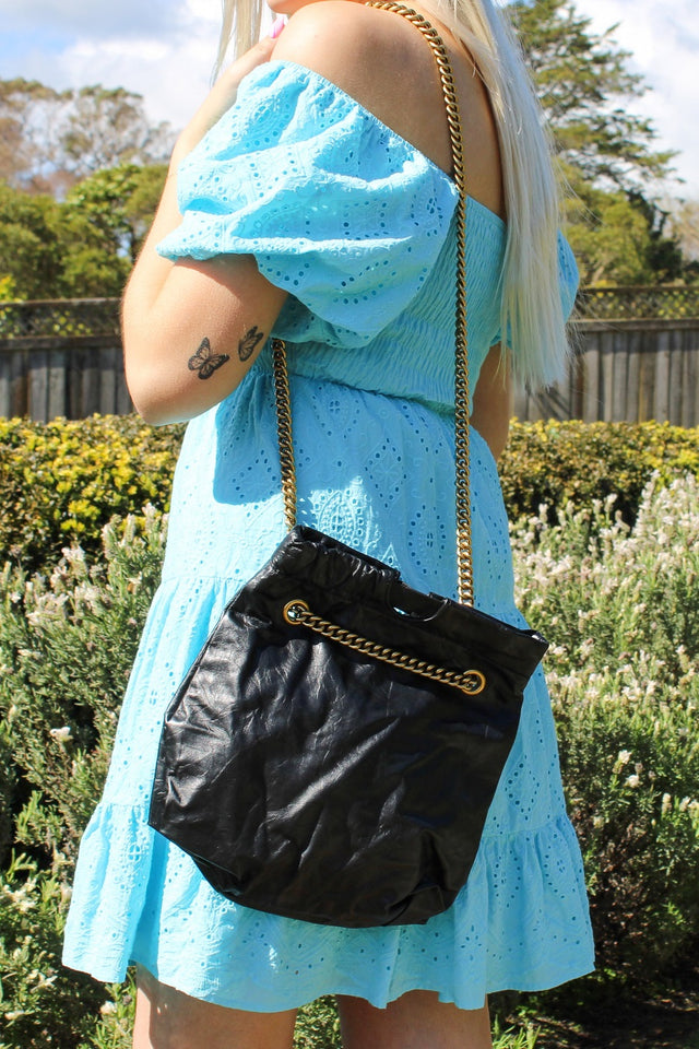 Black leather handbag with gold strap