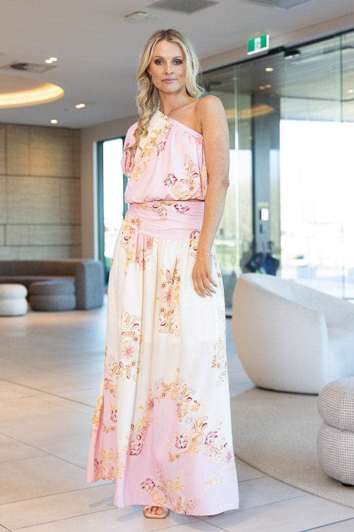 light pink maxi skirt with a cream base and a pink, yellow, and orange floral pattern