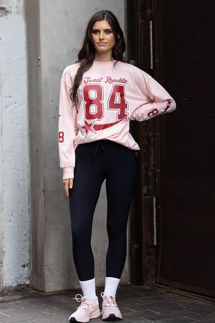 pink long-sleeve top with Sweat Republic 84 design