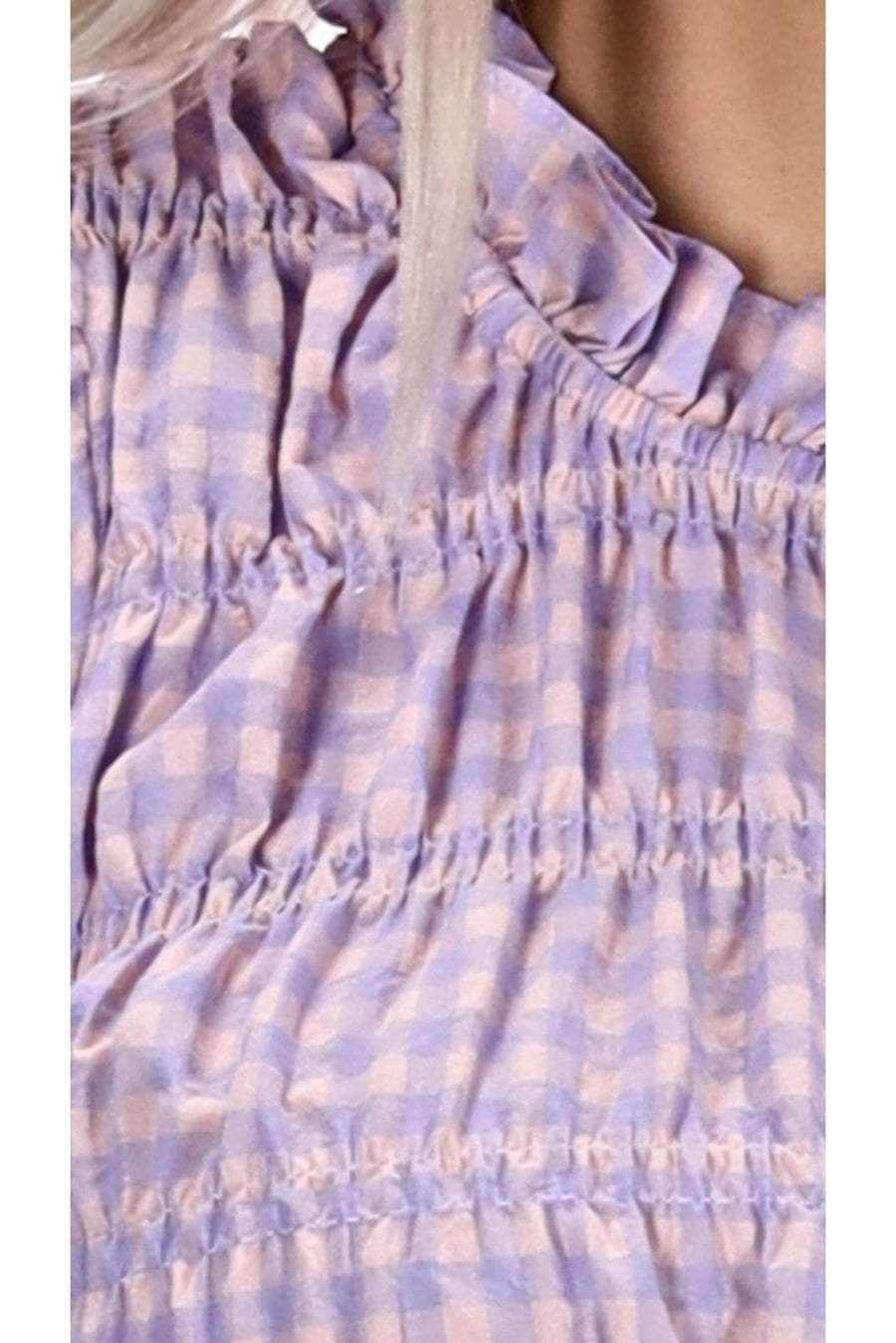 A lilac gingham print top with shirred seams