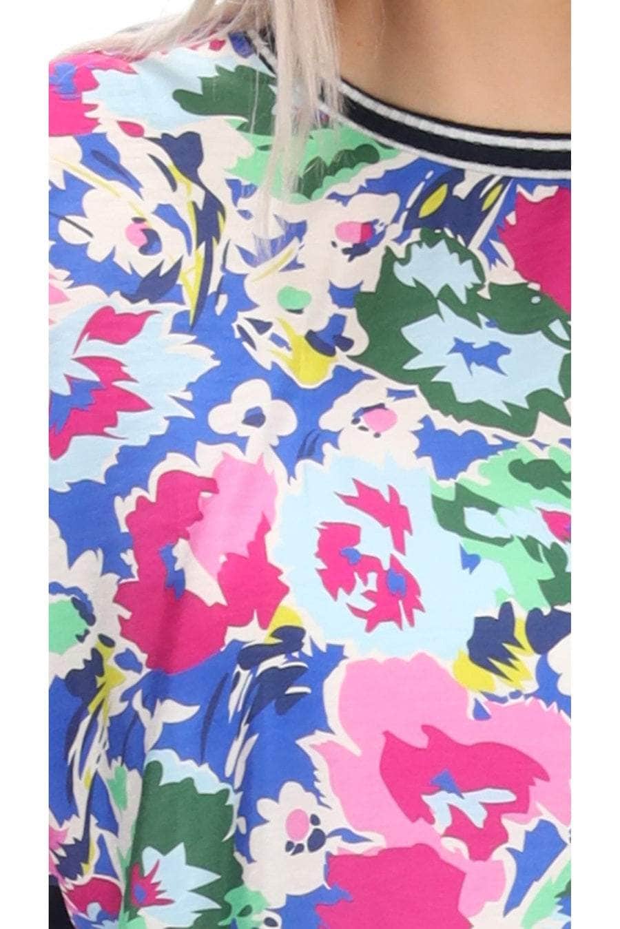 A blue floral print top with a navy back striped ribbing