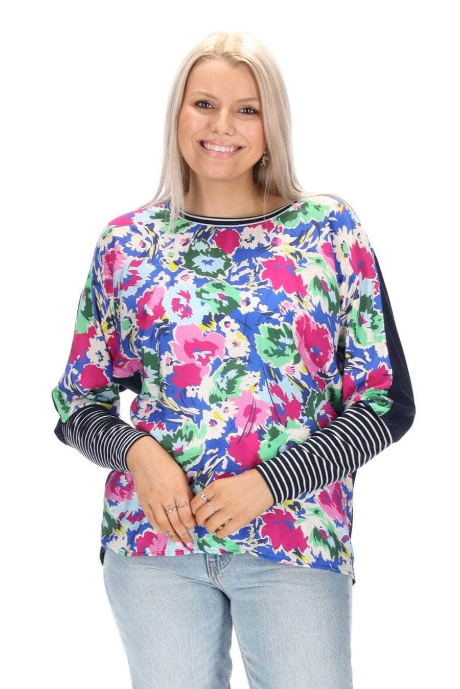 A blue floral print top with a navy back striped ribbing