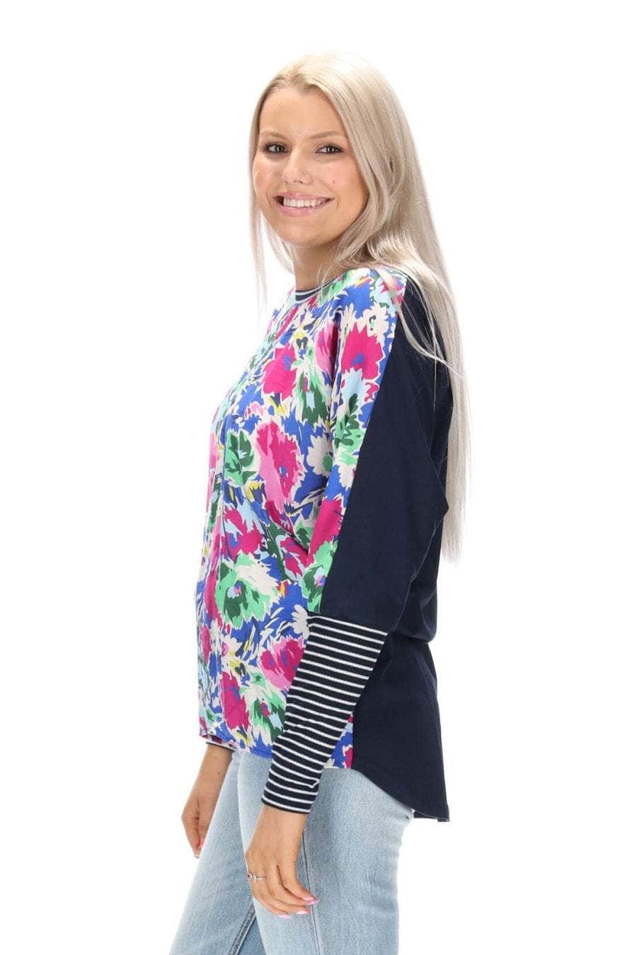 A blue floral print top with a navy back striped ribbing
