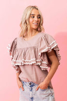 beige brown tan top with layers of gathered frills white trim ric rac