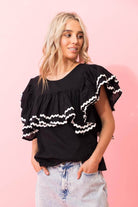black top with layers of gathered frills white trim ric rac