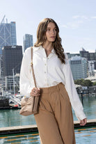 white button up long sleeve shirt with caramel stitching