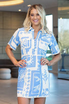 short-sleeve button-front dress with a blue and white patchwork-style floral and geometric print
