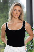black scoop-neck singlet with white scalloped trim along the neckline