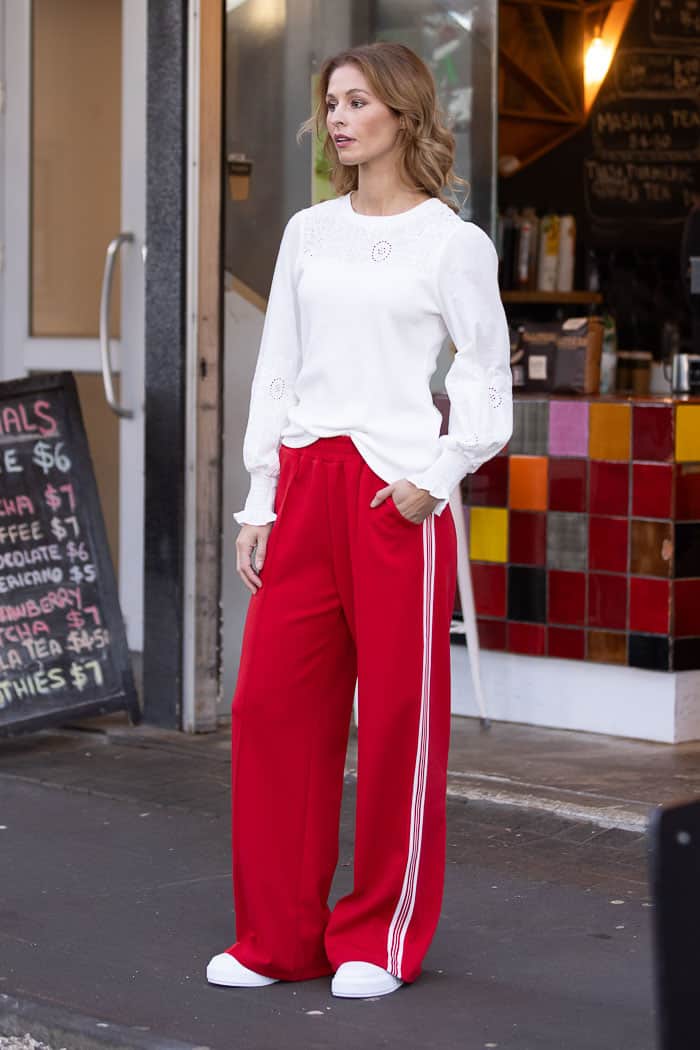 red wide leg trackpant with white side stripes
