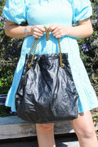 Black leather handbag with gold strap