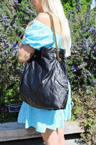 Black leather handbag with gold strap