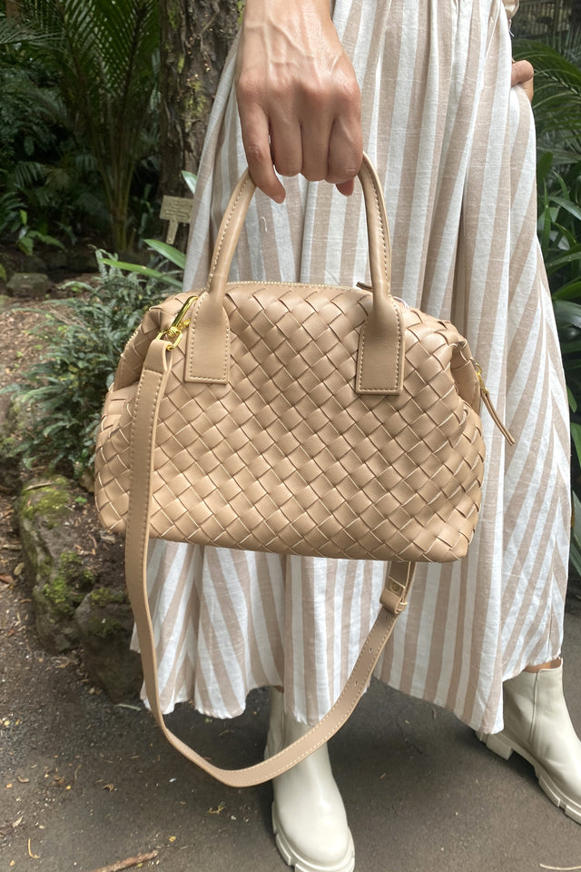 beige woven handbag with shoulder strap