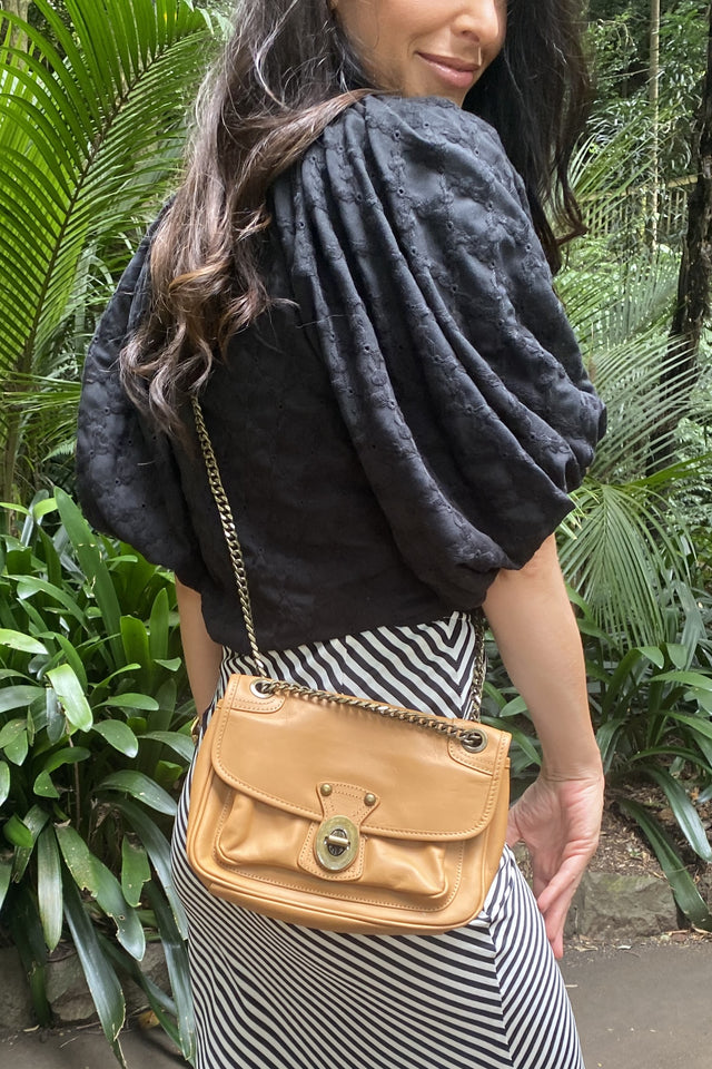 Tan leather handbag with bronze chain strap