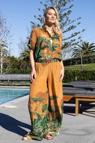 vibrant orange and green tropical print pants