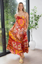 vibrant, multicolored bohemian-style maxi dress with spaghetti straps and a flowy, patterned fabric