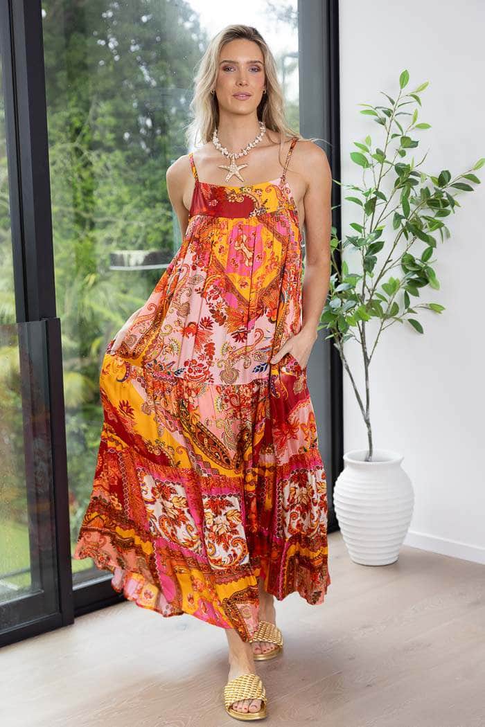 vibrant, multicolored bohemian-style maxi dress with spaghetti straps and a flowy, patterned fabric
