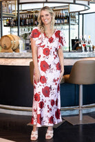 satin pink maxi dress with a bold red floral print