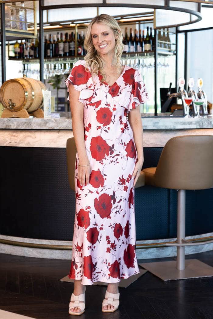 satin pink maxi dress with a bold red floral print