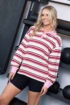 long-sleeve rugby-style top with red, pink, and off-white horizontal stripes
