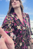 black wrap floral dress with hot pink piping trim