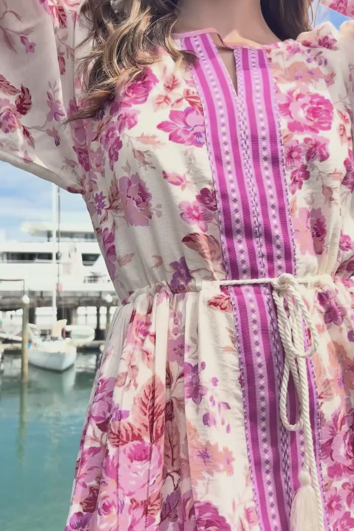 long sleeve pink floral mini dress with pink border trim