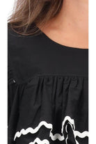 black top with layers of gathered frills white trim ric rac