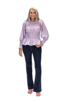 A lilac gingham print top with shirred seams