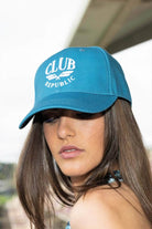 teal sports cap with white logo