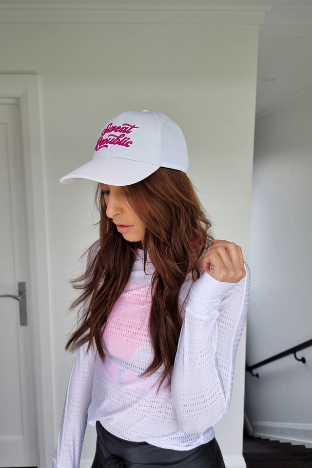White sports cap with pink logo